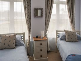 A bedroom with twin beds and a nightstand at 4 The Salcombe in Salcombe