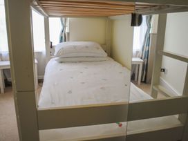 A bedroom with a bed and nightstand at 4 The Salcombe Salcombe