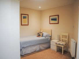 A bedroom with single bed and chair at 4 The Salcombe in Salcombe