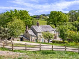 An outdoor view of a house surrounded by trees at French Mill in Shaftesbury