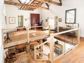 A living room with a balcony and telescope at French Mill in Shaftesbury