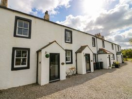 A view of a house with a gravel driveway at Bramble near Cleator Moor