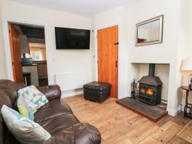 A living room with a sofa and fireplace at Bramble near Cleator Moor