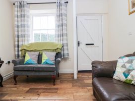 A living room with a sofa and doorway at Bramble near Cleator Moor
