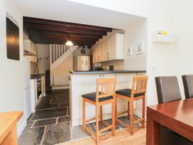 A kitchen with stools and a countertop at Bramble near Cleator Moor