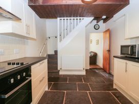 A kitchen with staircase and appliances at Bramble near Cleator Moor