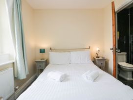 A bedroom with a double bed and towels at Bramble near Cleator Moor