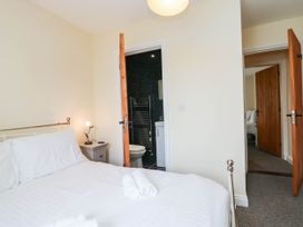 A bedroom with a bed and adjacent bathroom at Bramble near Cleator Moor