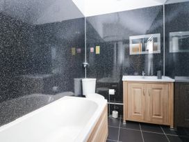 A bathroom with a bathtub, toilet, and sink at Bramble near Cleator Moor
