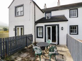 An outdoor area with a table and chairs at Bramble near Cleator Moor