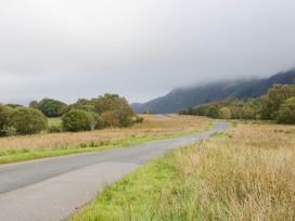 A road with grass and trees in a landscape near Cleator Moor
