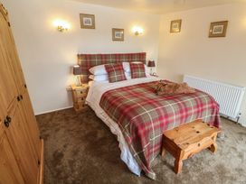 A bedroom with a bed and wardrobe at The Hideaway at Monterey in Helston