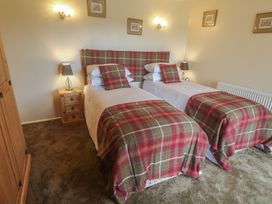 A bedroom with two single beds and bedside tables at The Hideaway at Monterey Helston