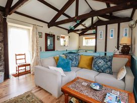 A living room with a sofa and coffee table at The Jingle House in Tregony