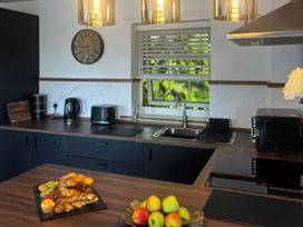A kitchen with countertop, sink, kettle, toaster, microwave and fruit at Truly Scrumptious in Yarm