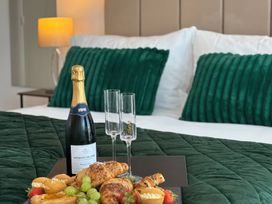 A bedroom with food and drink on a bed at Truly Scrumptious in Yarm