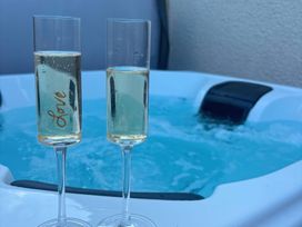 Two champagne glasses near a hot tub at Truly Scrumptious in Yarm