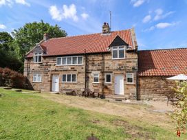 A house with a garden and chairs at Farmhouse in Whitby