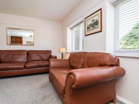 A living room with a sofa and lamp at Farmhouse in Whitby
