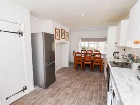 A kitchen with a dining area and a refrigerator at Farmhouse in Whitby