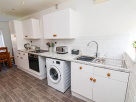 A kitchen with cabinets, a sink, and appliances at the Farmhouse in Whitby