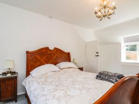 A bedroom with a wooden bed and nightstand at Farmhouse in Whitby