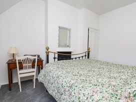 A bedroom with a bed and desk at the Farmhouse in Whitby