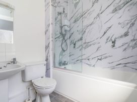 A bathroom with a bathtub and shower at Farmhouse in Whitby
