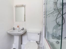 A bathroom with a sink, toilet, and shower at Farmhouse in Whitby