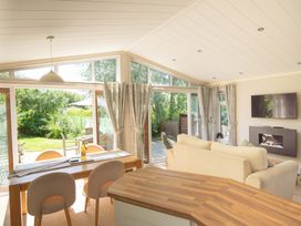 A living room with a dining table and sofa at Oak Lodge