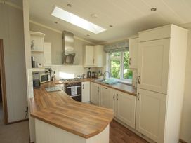 A kitchen with cabinets and appliances at Oak Lodge