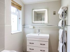 A bathroom with a sink and towels at Oak Lodge Battisford near Stowmarket