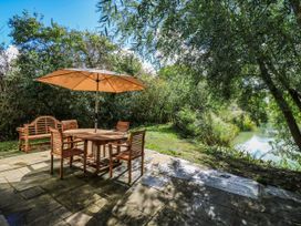 An outdoor dining area with a table and chairs at Oak Lodge in Battisford near Stowmarket