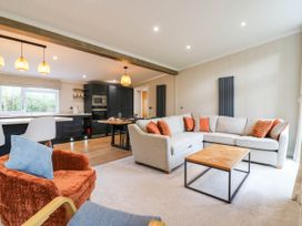 A living room with a sofa and coffee table at Cherry Lodge in Battisford near Stowmarket