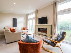 A living room with a sofa and television at Cherry Lodge Battisford near Stowmarket