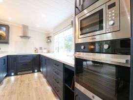 A kitchen with modern appliances and cabinets at Cherry Lodge Battisford near Stowmarket