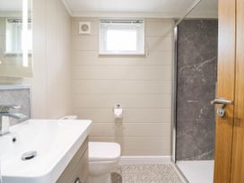 A bathroom with a sink, toilet and shower at Cherry Lodge in Battisford near Stowmarket