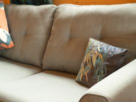 A sofa with cushions at Willow Lodge in Stowmarket