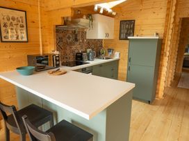A kitchen with countertop and appliances at Willow Lodge in Stowmarket