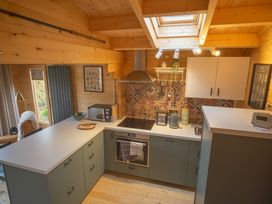 A kitchen with appliances and counter space at Willow Lodge in Stowmarket