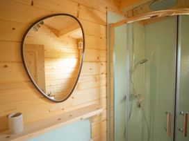 A bathroom with a shower and a mirror at Willow Lodge Stowmarket