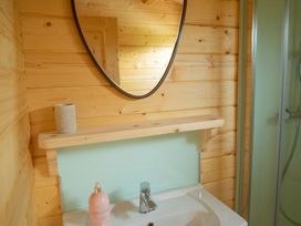 A bathroom with a sink and mirror at Willow Lodge in Stowmarket