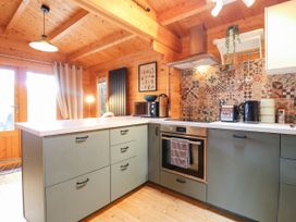 A kitchen featuring an oven and coffee maker at Willow Lodge Stowmarket