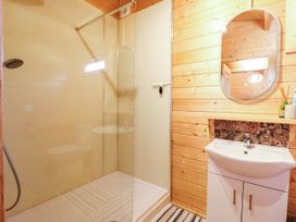 A bathroom with a shower and sink at Willow Lodge in Stowmarket