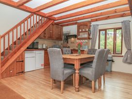 A kitchen with table and chairs at Brimble Cottage at Dockwell Farm in Newton Abbot