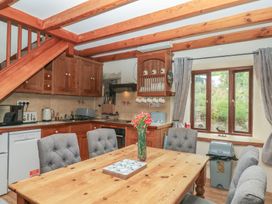 A kitchen with a dining table and chairs at Brimble Cottage at Dockwell Farm, Newton Abbot