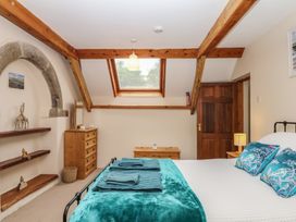 A bedroom with a bed and dresser at Brimble Cottage at Dockwell Farm Newton Abbot