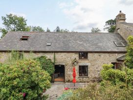 A stone building with a slate roof and garden at Brimble Cottage at Dockwell Farm, Newton Abbot