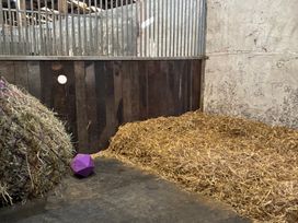 A stable with hay, straw, and a purple ball at Brimble Cottage at Dockwell Farm near Widecombe-In-The-Moor