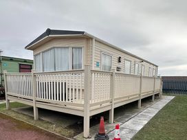 A caravan with a deck at Golden Sands FSB38 in Rhyl